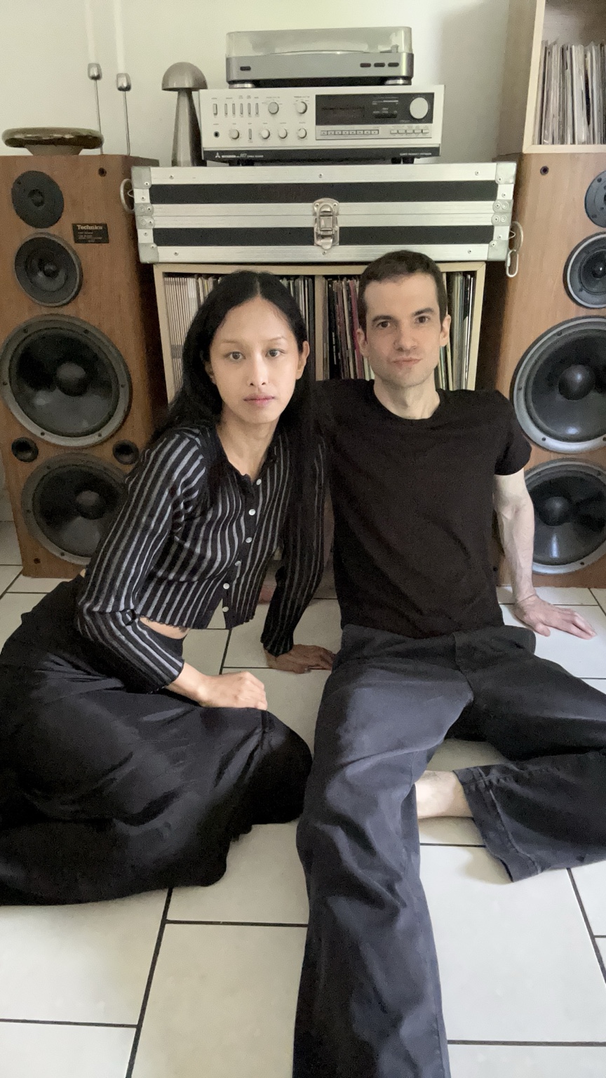 Dahlia and Tobias Rochman seated together between studio speakers and records